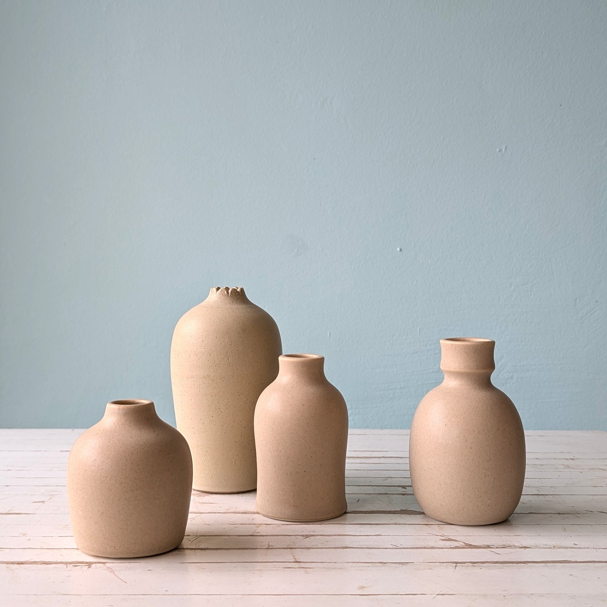 Four sand coloured bud vases by Asahi So