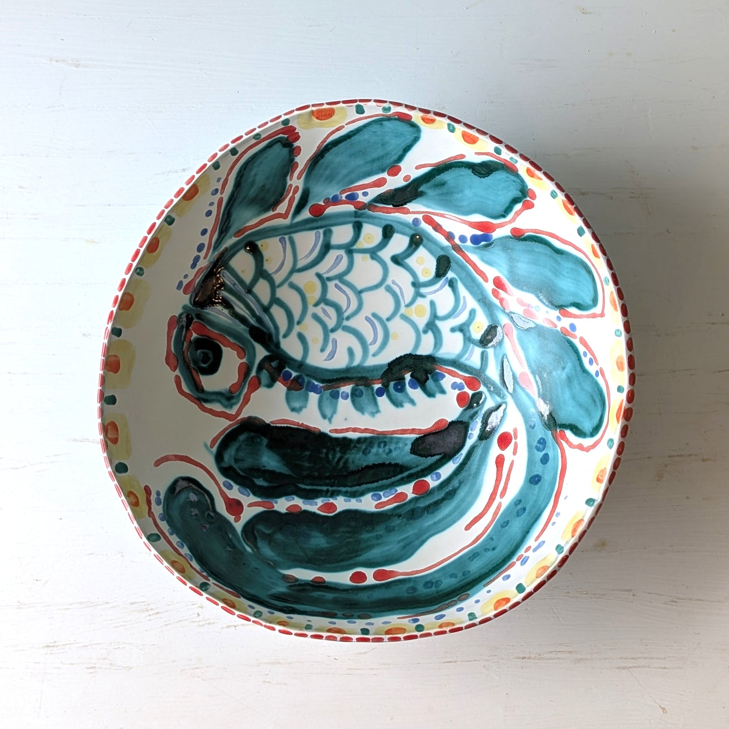 Ceramic bowl with fish design on a white background
