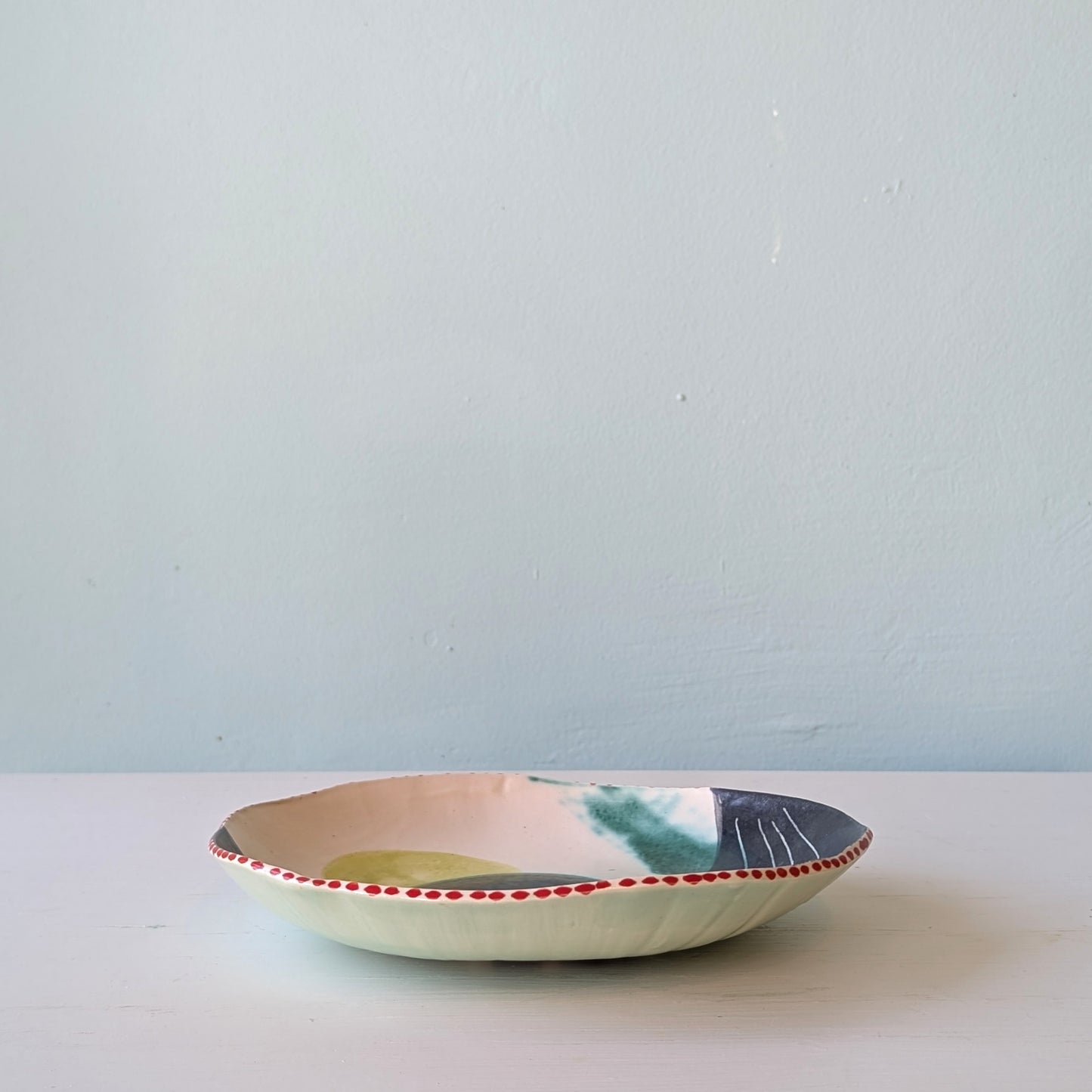 Ceramic bowl with abstract design on a light blue background