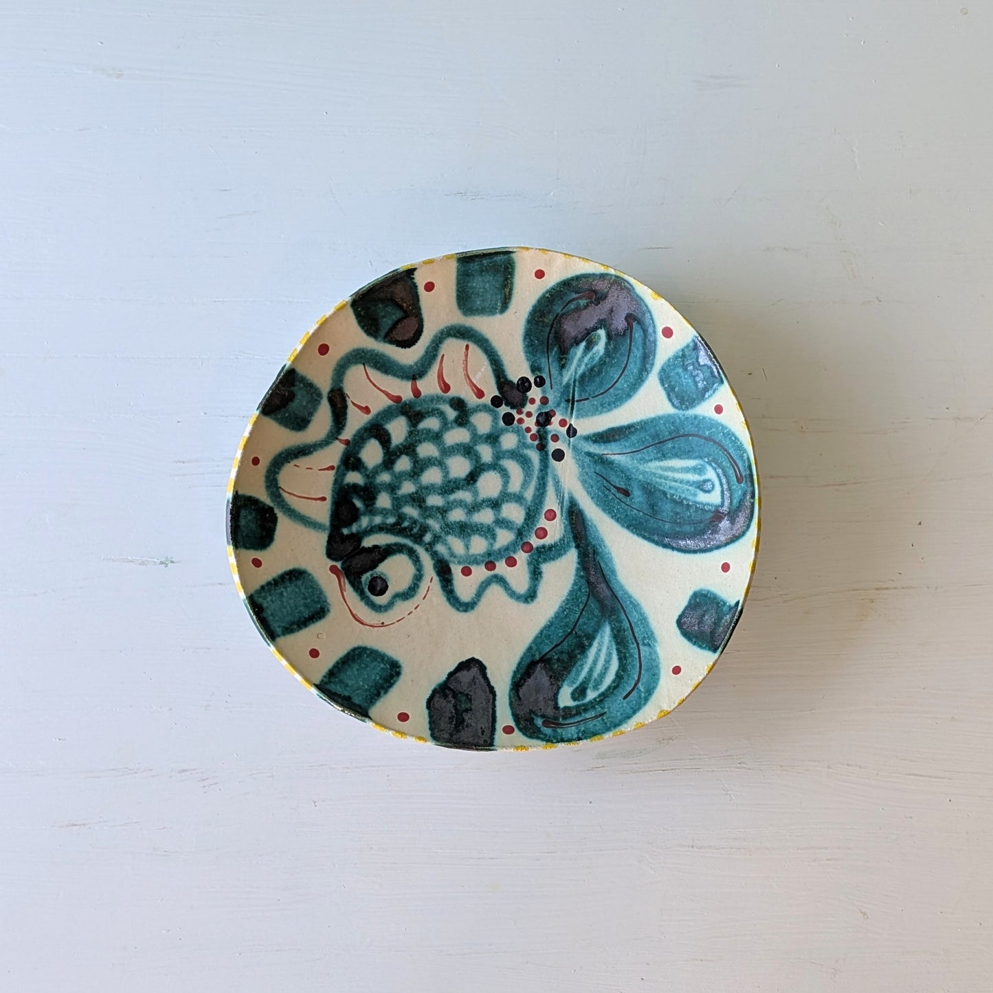 Ceramic dish with fish design on a white background