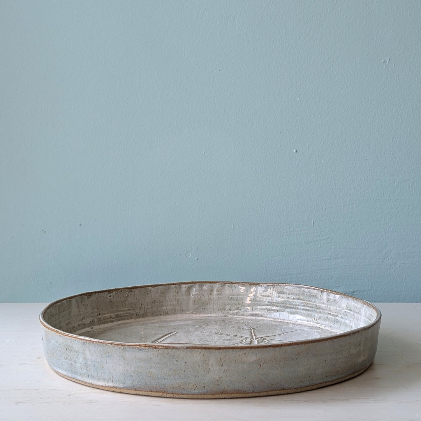 Round ceramic bowl on a light blue background