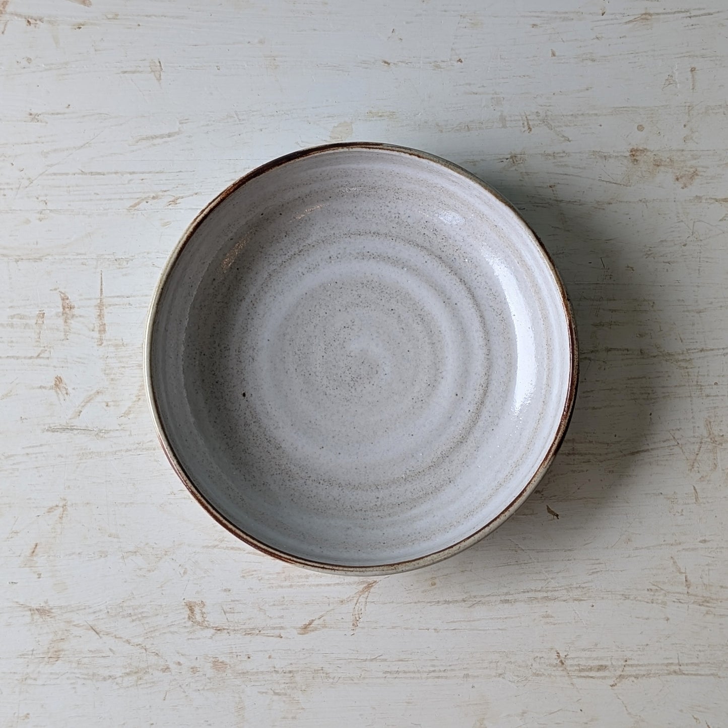 Ceramic bowl on a textured white surface