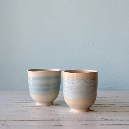 two ceramic cups with pale blue glaze