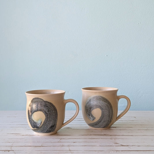 two stoneware mugs with blue swirl patter