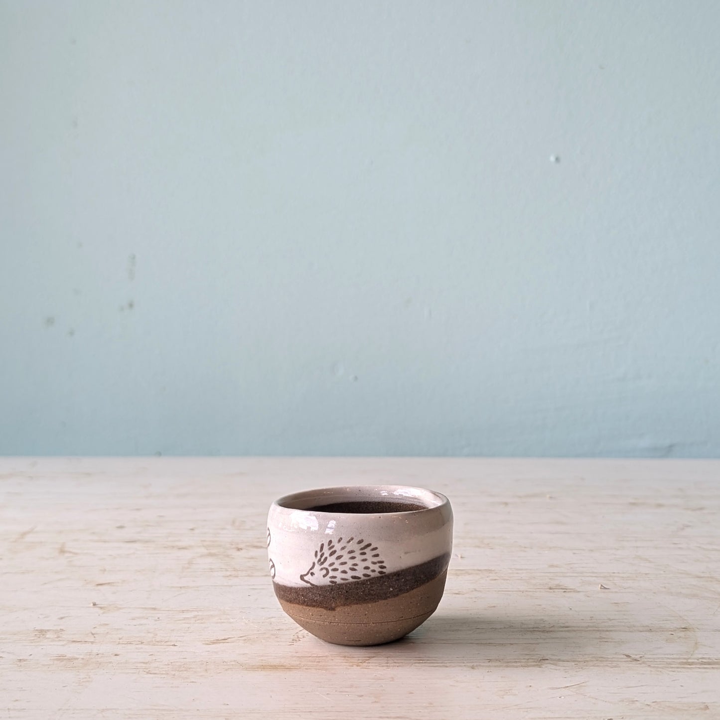 Small ceramic cup with hedgehog pattern
