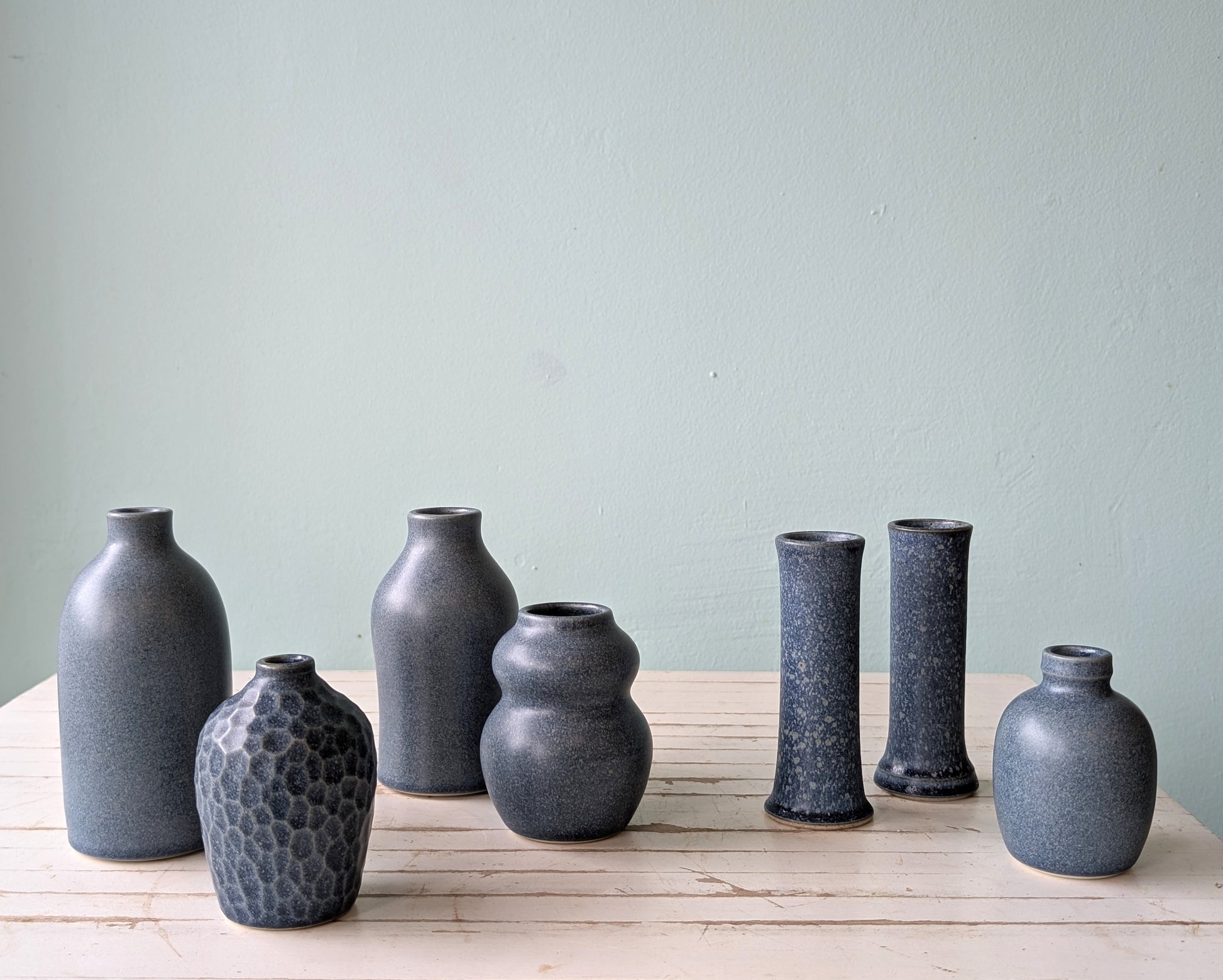 Collection of 7 ceramic bud vases in denim blue glaze by Asahi So