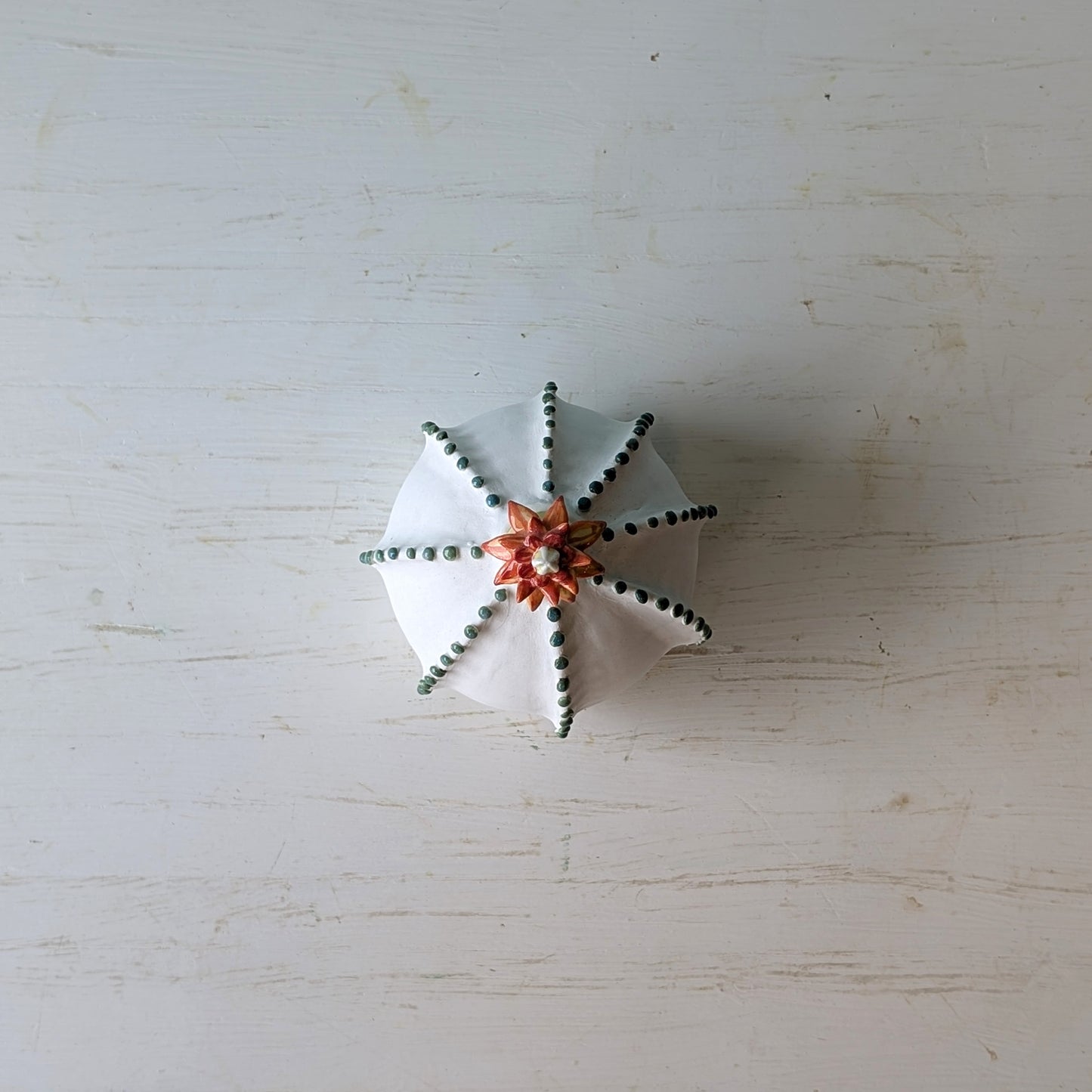 Small decorative vase on a light wooden surface