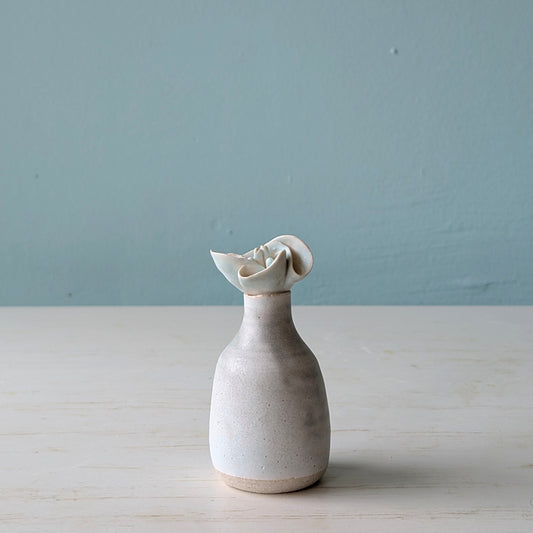 Small ceramic bottle with flower design on lid