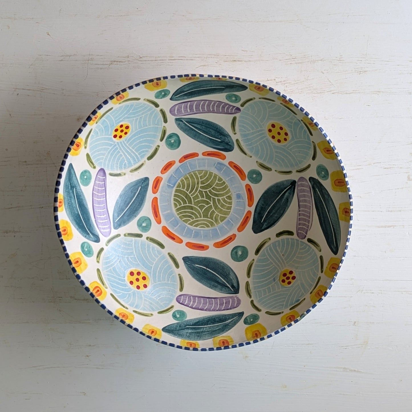 Decorative ceramic bowl with floral patterns on a white background