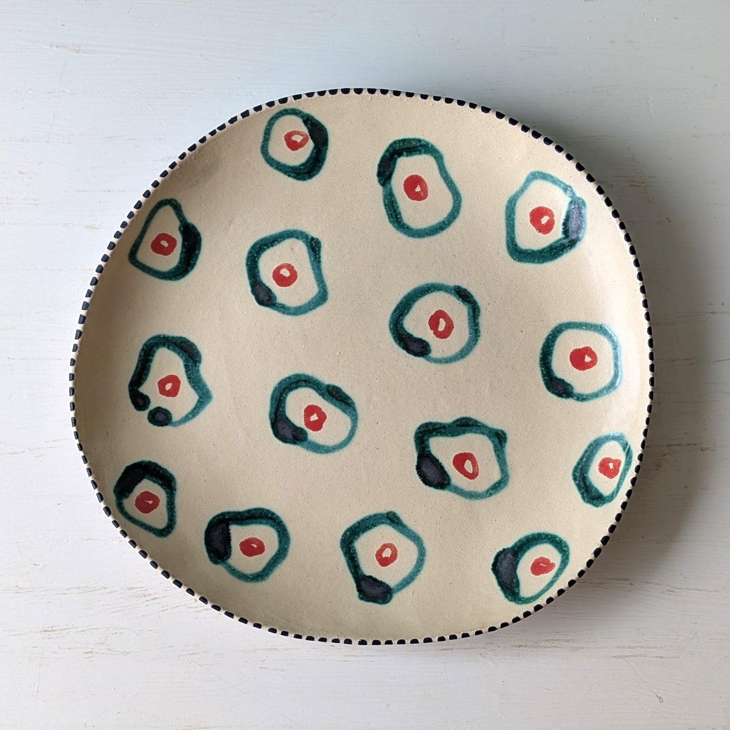 Ceramic platter with abstract design on a white surface