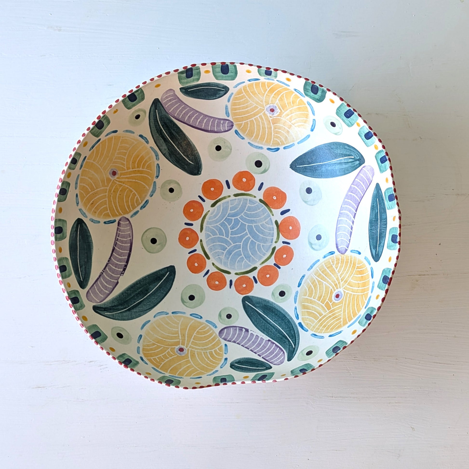 Decorative ceramic plate with colorful abstract design on a white background