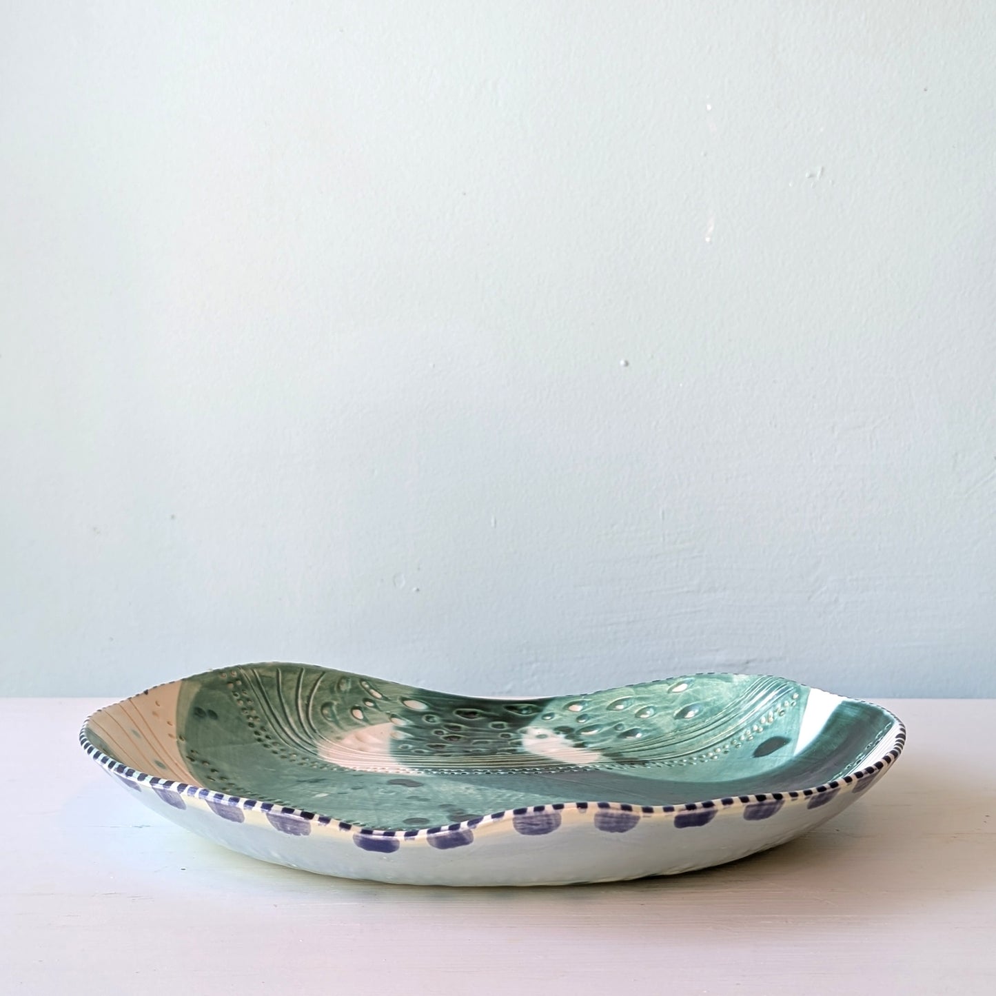 Ceramic platter with decorative patterns on a white background