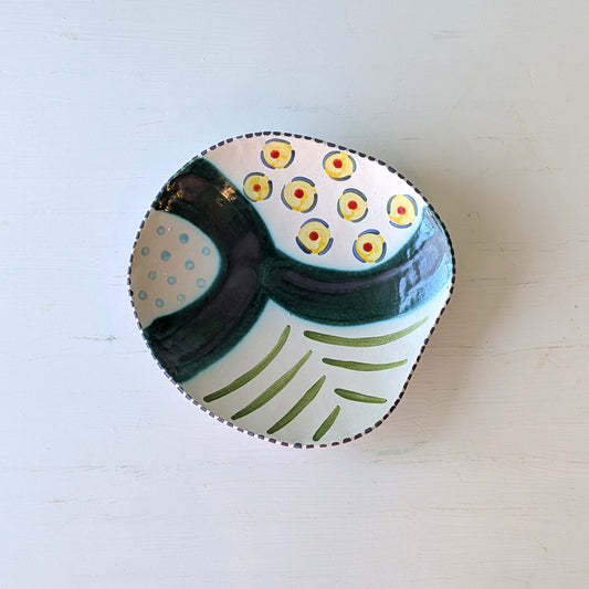 Ceramic bowl with decorative patterns on a white surface