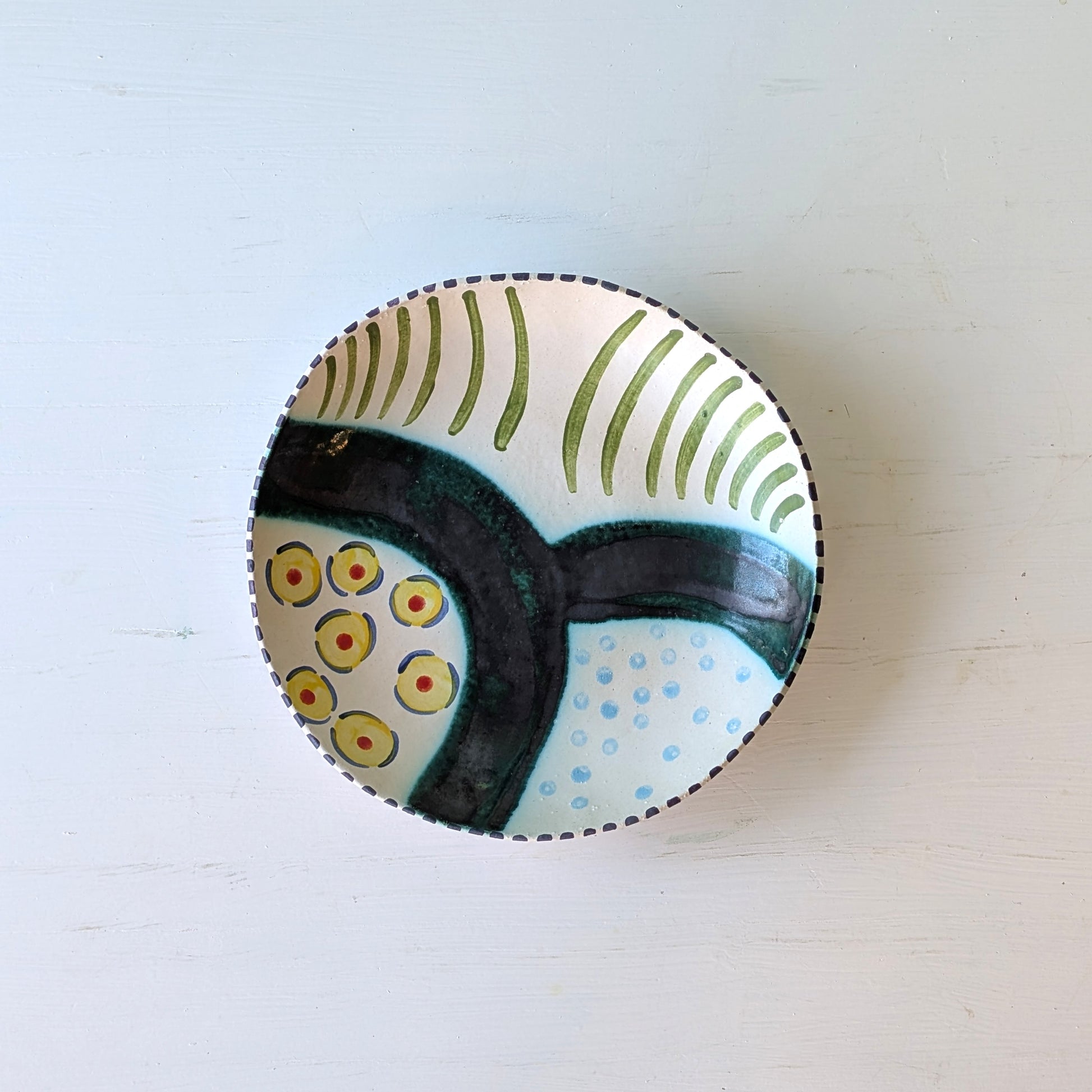 Round ceramic bowl with abstract design on a white background