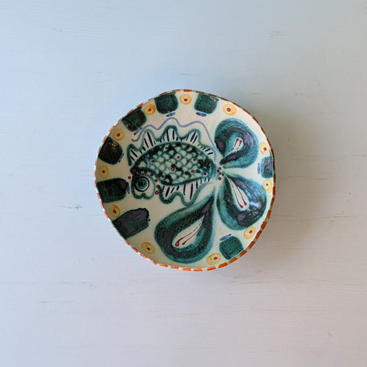 Ceramic bowl with fish design on a white background