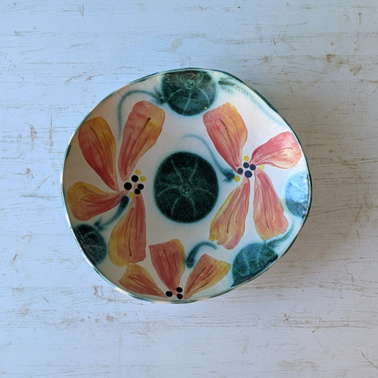 Ceramic bowl with floral design on a light blue background