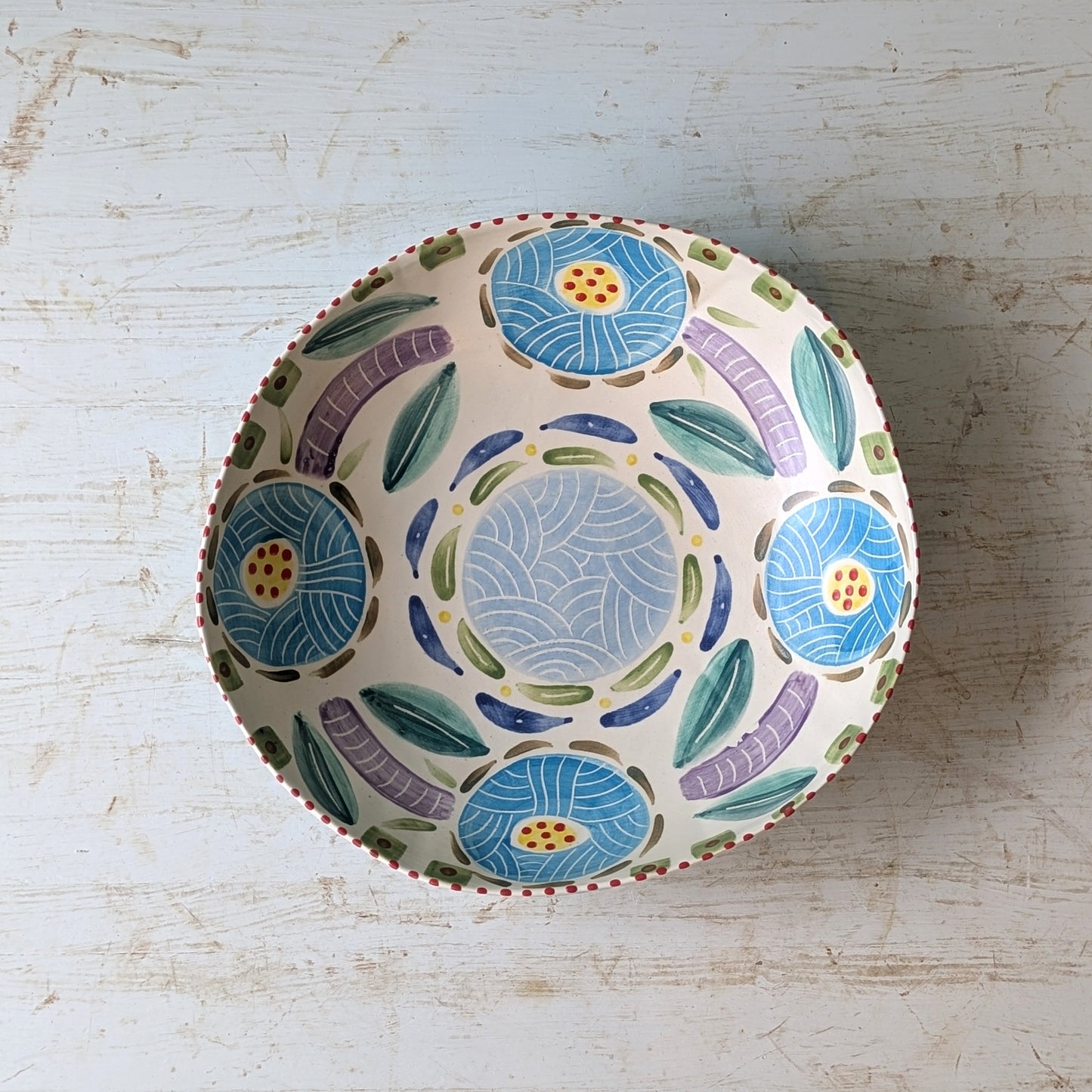 Decorative ceramic bowl with floral pattern on a wooden surface