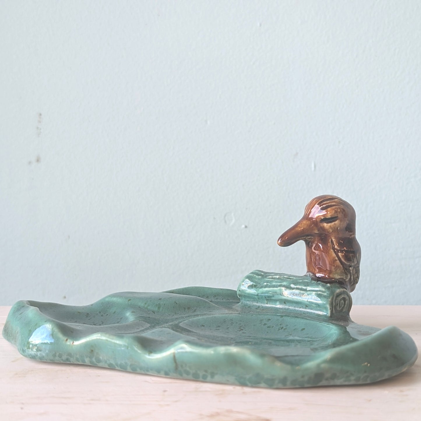 Ceramic kookaburra dish with a light blue background