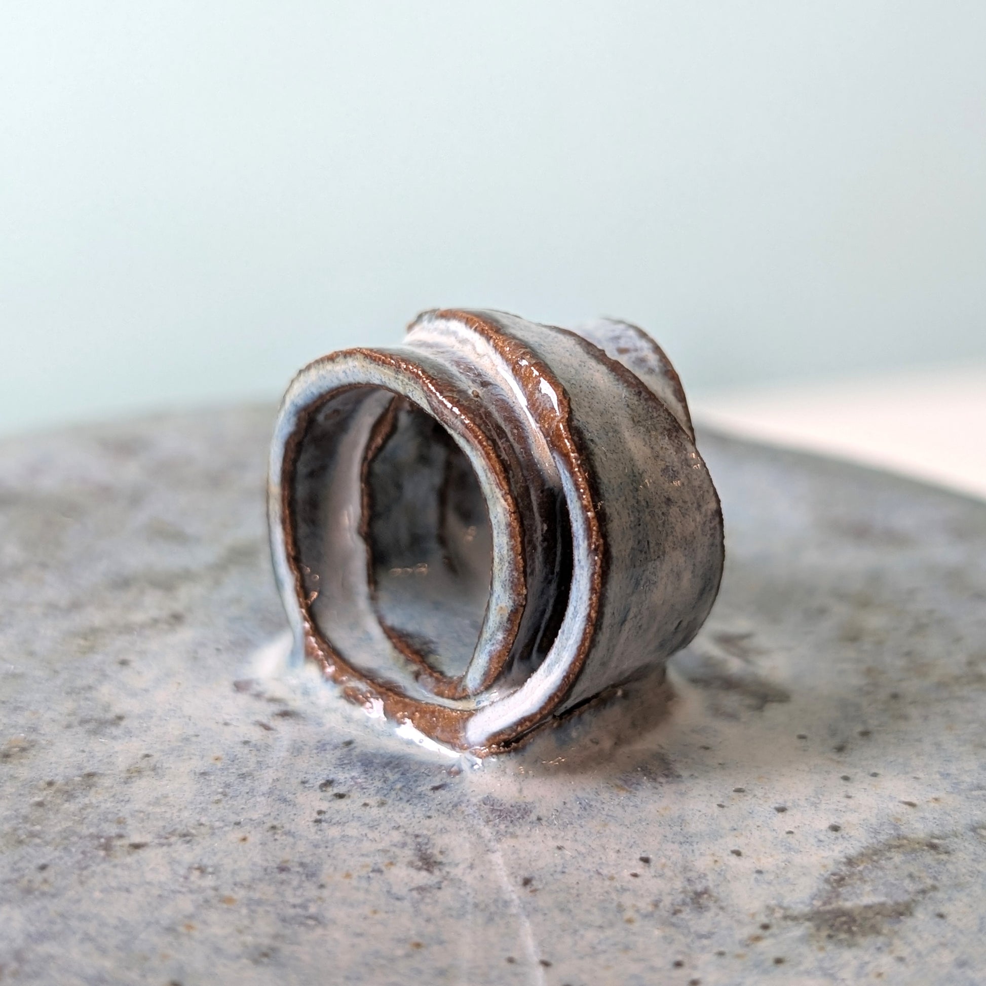 Close up of folded gum leaf lid on ceramic cannister