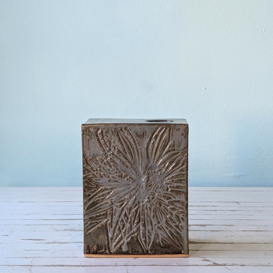 Front view of a blue/grey ceramic rectangular vase with linocut flower pattern