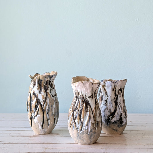 Three abstract ceramic vases with bark-like texture