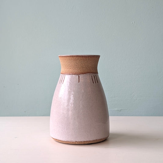 Ceramic vase with two-tone design on a light blue background