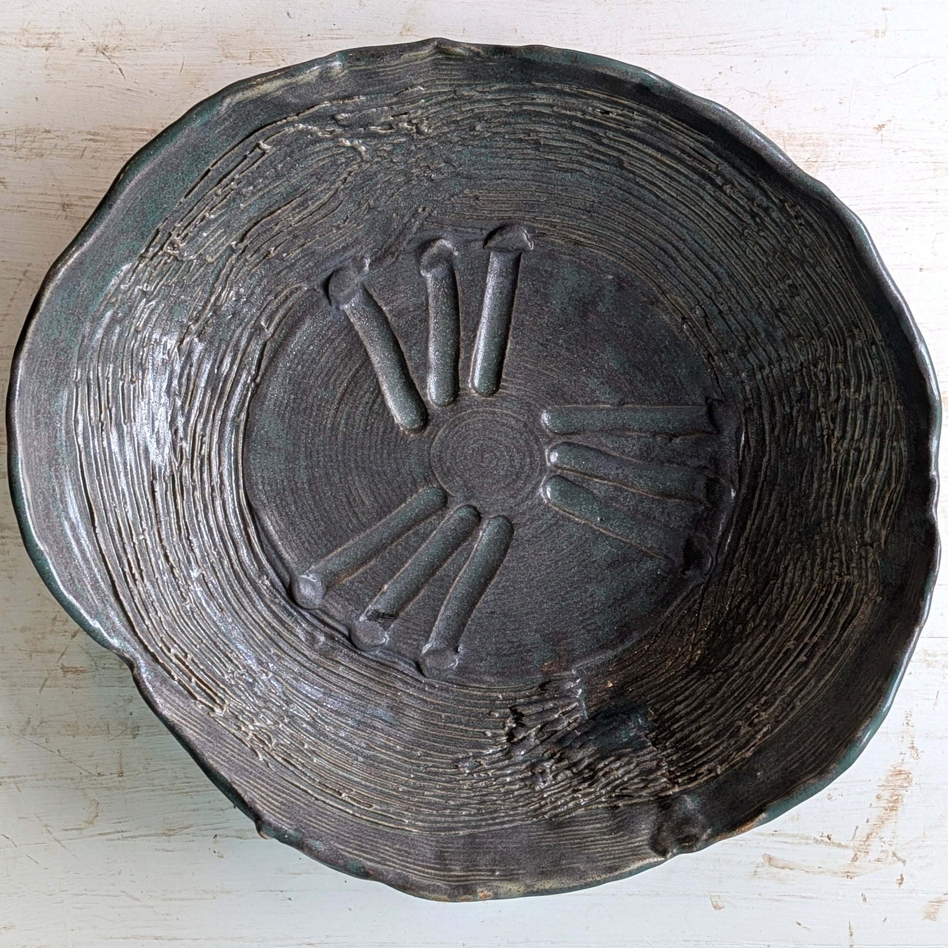 Large textured ceramic bowl on a white table.
