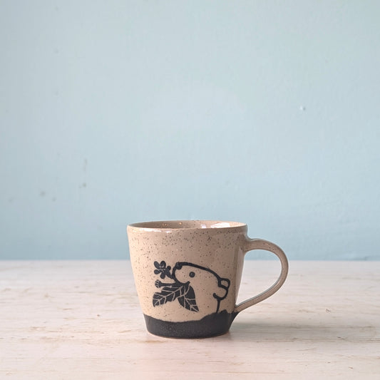 Ceramic mug with animal  design on a light blue background